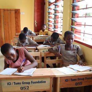 children sitting at desks in school classroom