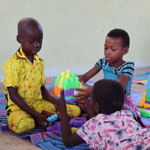 children playing with plastic blocks in a child-friendly space in cote d'ivoire