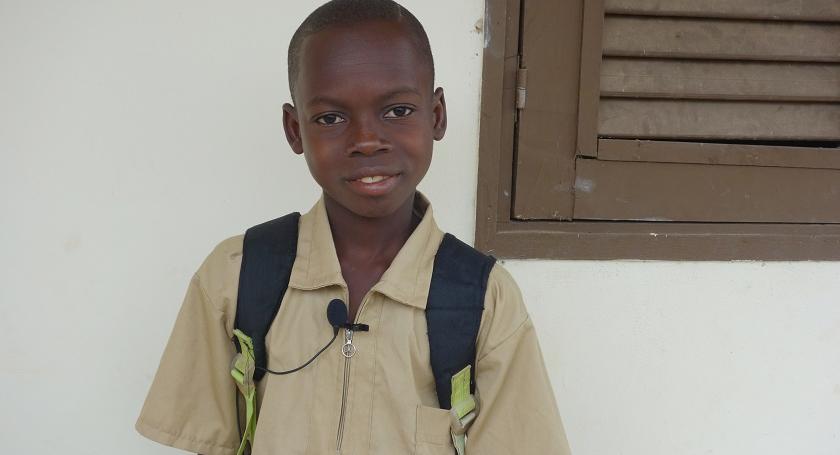 Kouassi Yao Menza is happy to learn in a new school.