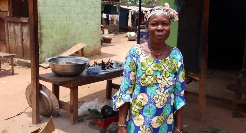 Woman posing next to her food stall