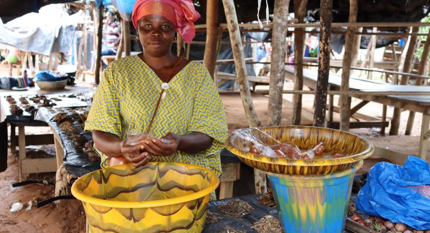 Woman posing next to her food stall