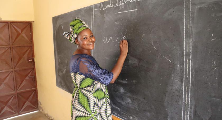 Micheline writing in a blackboard