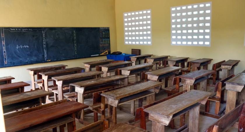 new school classroom with wooden tables and blackboard