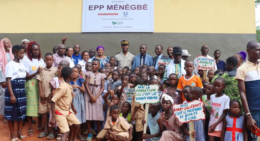 school children posing in front of new school